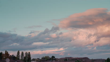 Timelapse-of-the-Sky---Clouds-moving-during-a-Sunset-Golden-Hour-with-beautiful-Pink-and-Orange-Colors