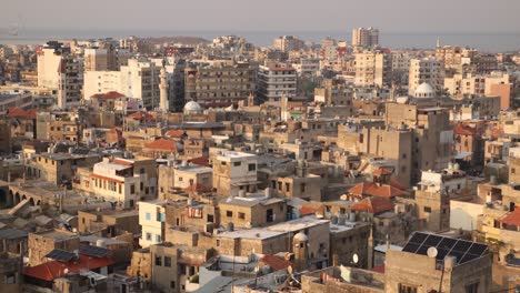 aerial-panning-view-of-old-arab-town-with-mosque-and-minaret-in-Tripoli,-Northern-Lebanon
