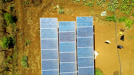 Aerial-drone-view-into-large-solar-panels-at-a-solar-farm-at-bright-sunset