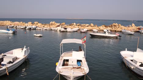 boats-with-lebanese-flag-waving-in-the-mediterranean-harbor-in-Tripoli,-Northern-Lebanon