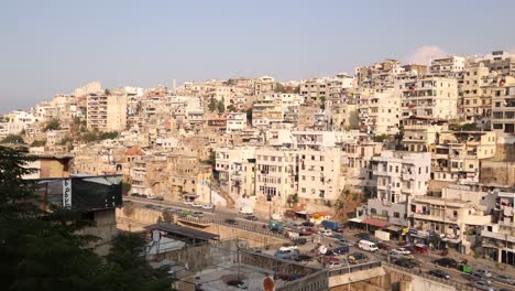 roads-driving-along-road-beneath-towering-middle-eastern-homes-on-the-hillside-above-Tripoli,-Northern-Lebanon