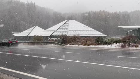 Red-Bull-headquarter-in-Fuschl-Am-See-on-a-snowy-day,-seen-from-the-road,-day