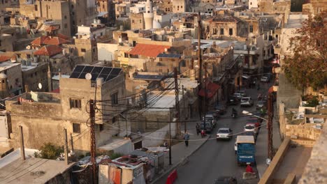 cars-driving-down-an-old-road-towards-the-historic-arab-old-town-of-Tripoli,-Northern-Lebanon