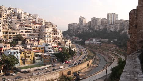 view-of-middle-eastern-village-on-the-hillside-with-road-cutting-through-the-valley-in-Tripoli,-Northern-Lebanon