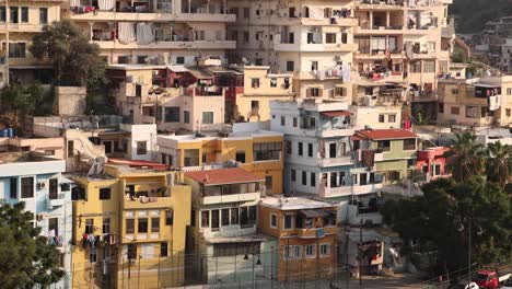 panning-shot-of-middle-eastern-city-built-on-the-hillside-at-sunset-in-Tripoli,-Northern-Lebanon
