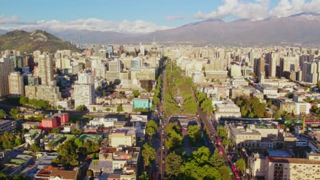 Aerial-view-overlooking-Alameda-street-lush-Poplar-trees-Santiago-Centro-modern-cityscape-under-Andes-mountains