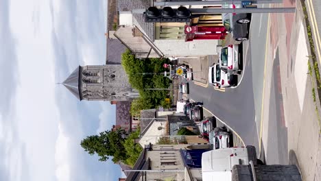 Sunny-Day-in-Kilcock:-Vertical-Video-of-Town-Life-with-St-Coca's-Catholic-Church,-Pedestrian-Crossing,-and-Urban-Activity-in-County-Kildare