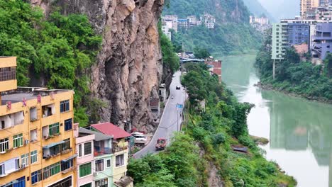 Aerial-drone-shot-of-a-riverside-road-in-Yanjin-City-at-Yunnan-Province