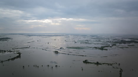 Aerial-timelapse-of-wispy-clouds-flying-over-the-flooded-fields-in-Cambodia