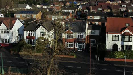 Aerial-view-expensive-British-middle-class-town-houses-in-rural-suburban-neighbourhood