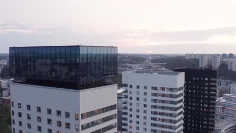 Drone-footage-of-high-rise-residential-buildings-with-modern-design-and-architecture-in-Årstadal,-Stockholm