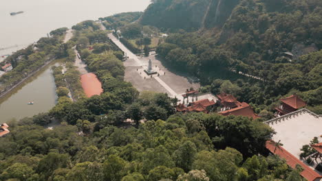 Soar-above-Nansha-Tin-Hau-Palace-with-our-mesmerizing-aerial-drone-shot-capturing-the-serene-beauty-of-the-goddess-statue-and-Tin-Hau-Square,-a-perfect-blend-of-tradition-and-spirituality