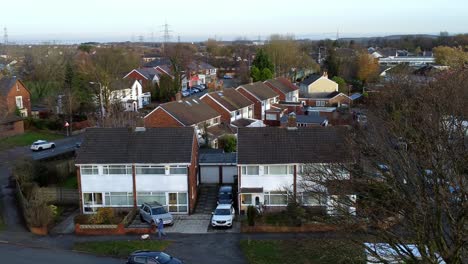 Rainhill-typical-British-suburban-village-in-Merseyside,-England-aerial-view-pan-across-Autumn-residential-council-neighbourhood