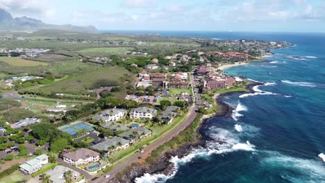 Stunning-aerial-view-capturing-oceanfront-resort-hotels,-beach,-blue-ocean-and-mountain-landscape