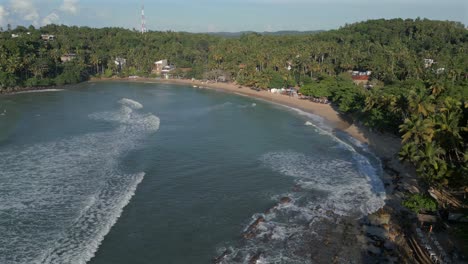 Establishing-Aerial-Drone-Shot-of-Hiriketiya-Sandy-Beach-and-Bay-in-Southern-Sri-Lanka-on-Sunny-Day