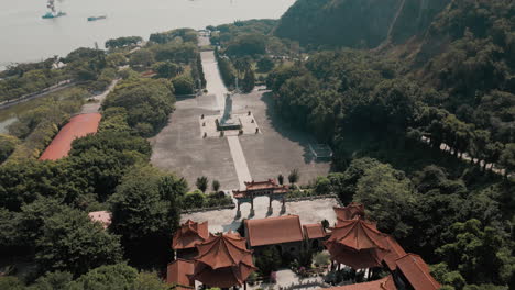 Embark-on-a-celestial-journey-with-our-mesmerizing-aerial-drone-orbit-shot,-gracefully-circling-the-goddess-statue-and-Tin-Hau-Square-at-Nansha-Tin-Hau-Palace