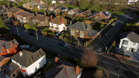 Aerial-view-looking-down-over-expensive-British-middle-class-houses-in-rural-suburban-neighbourhood