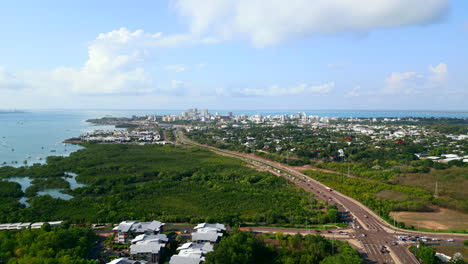 Areal-panorama-following-a-freeway-into-a-coastline-city