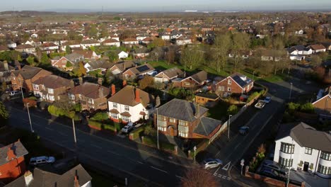Aerial-view-expensive-British-middle-class-houses-in-autumn-rural-suburban-neighbourhood