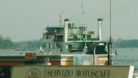 A-ferryboat-ACTV-driving-past-Venice-with-smoke-coming-out-of-the-smokestacks