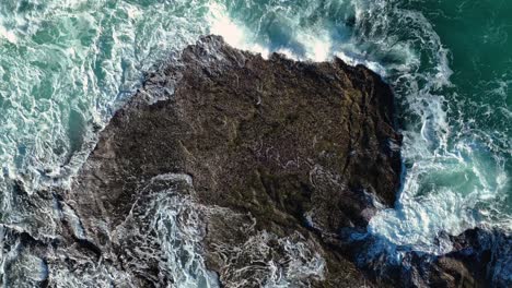 Overhead-View-Of-Foaming-Sea-Waves-Hitting-Rocky-Shore