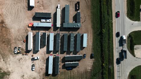 Overhead-4K-Time-Lapse-Group-of-a-Workplace-Exterior-Housing-Job-Site-Temporary-Construction-Forman-Portable-Site-Prefabricated-Mobility-Trailers-Next-to-Busy-Road-Cars-and-Traffic