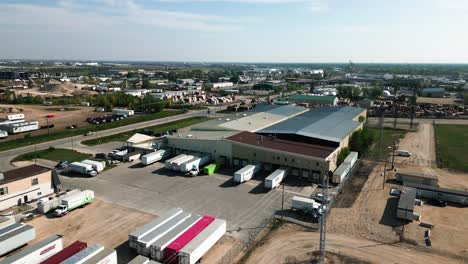 Establishing-4K-Drone-Orbit-Loading-Bay-Semi-Trucks-Aerial-Shot-of-Industrial-Zone-Manufacturing-Landscape-Distribution-Center-District-in-Winnipeg-Manitoba-Canada