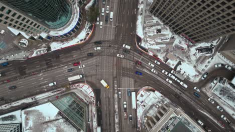 Overhead-Vehicle-Traffic-4K-Hyper-Time-lapse-Winter-Drone-Shot-Canadian-Roadway-Trans-Highway-One-Intersection-Portage-Avenue-and-Main-Street-Capital-City-Downtown-Winnipeg-Manitoba-Canada