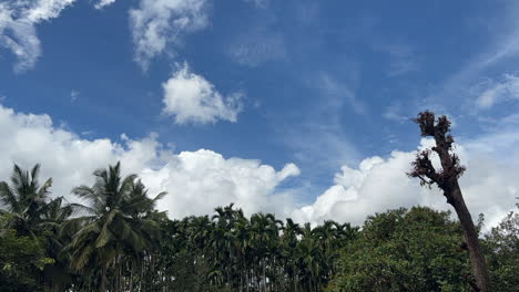 Scene-with-white-clouds-against-blue-sky-on-sunny-day-in-countryside