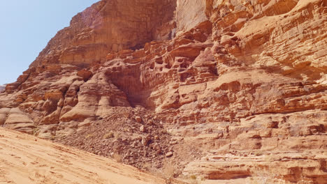 Close-up-tilt-up-shot-of-beautiful-rock-formation-in-Wadi-Rum,-Jordan