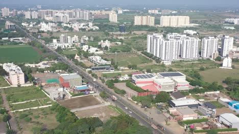 Right-side-of-Rajkot-city-aerial-view-construction-work-is-going-on,-big-solar-system-is-visible-in-tenement-behind