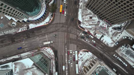 LONG-CLIP-Overhead-Vehicle-Traffic-4K-Time-lapse-Winter-Drone-Shot-Canadian-Roadway-Trans-Highway-One-Intersection-Portage-Avenue-and-Main-Street-Capital-City-Downtown-Winnipeg-Manitoba-Canada
