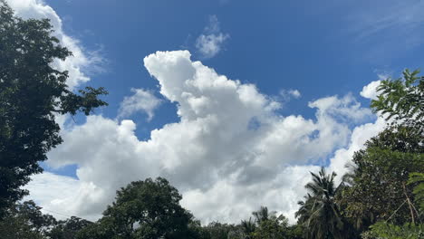 Cumulus-clouds-moving-against-the-blue-sky-in-the-sunny-day