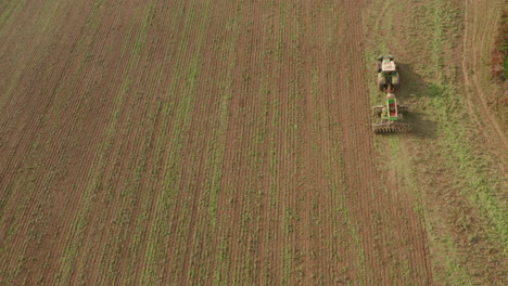 Overhead-aerial-shot-over-a-ploughing-tractor-to-the-right-of-frame