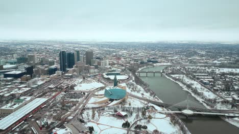 Establishing-Wide-Angle-Shot-Full-Canadian-Museum-of-Human-Rights-Urban-Winnipeg-Manitoba-Canada-Downtown-Skyscraper-Buildings-in-City-Overcast-Landscape-Skyline-Snowing-Winter-Drone-4k-Shot