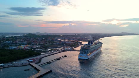 Wide-angle-overview-of-cruise-ship-docked-at-port-town-at-sunset-in-the-Caribbean