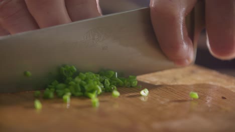 Chopping-Fresh-Green-Onions-on-Wooden-Cutting-Board