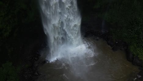 Powerful-waterfall-spraying-as-it-hits-the-ground-in-Bali,-Indonesia