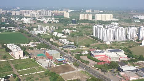 Rajkot-city-aerial-view-Drone-camera-is-going-downward-and-big-trees-are-visible-around