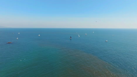 Sailboats-On-The-Calm-Turquoise-Ocean-Of-Dana-Point-In-California,-USA---Aerial-Drone-Shot