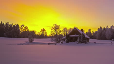 Time-lapse-winter-wonderland-snowy-log-cabin-in-woods-and-yellow-sunrise