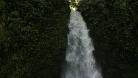 Nungnung-waterfall-with-light-breaking-through-at-the-top,-in-Bali,-Indonesia