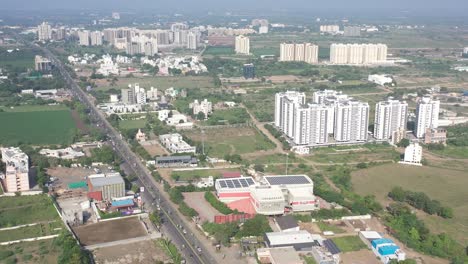 Rajkot-city-aerial-view-Camera-is-coming-with-lots-of-big-buildings,-and-lots-of-complexes