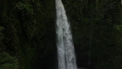 The-power-of-Nungnung-waterfall-on-a-sunny-afternoon-in-Bali,-Indonesia