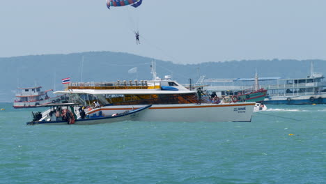 Ferries-waiting-for-passengers-to-do-their-parasiling-activity-in-front-of-Pattaya-Beach-in-the-province-of-Chonburi-in-Thailand