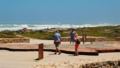 Tourists-looking-at-topographical-map-of-Africa-at-Agulhas-Southern-Tip-Monument