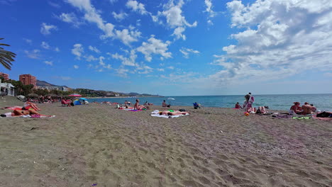 People-relaxing-on-the-Playa-de-La-Malagueta-Beach-in-Spain