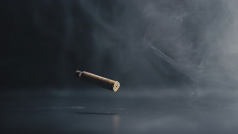 Bullet-Casing-Descending-with-Swirling-Smoke-in-Background