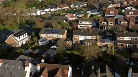 Rural-town-house-property-aerial-view-rising-over-looking-down-at-rooftops-and-gardens-in-middle-class-neighbourhood
