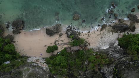 Birds-eye-view-of-an-isolated,-private-beach-in-the-South-of-Bali,-Indonesia,-aerial